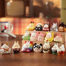 Collection of small animal figurines on a wooden surface with a blurred background